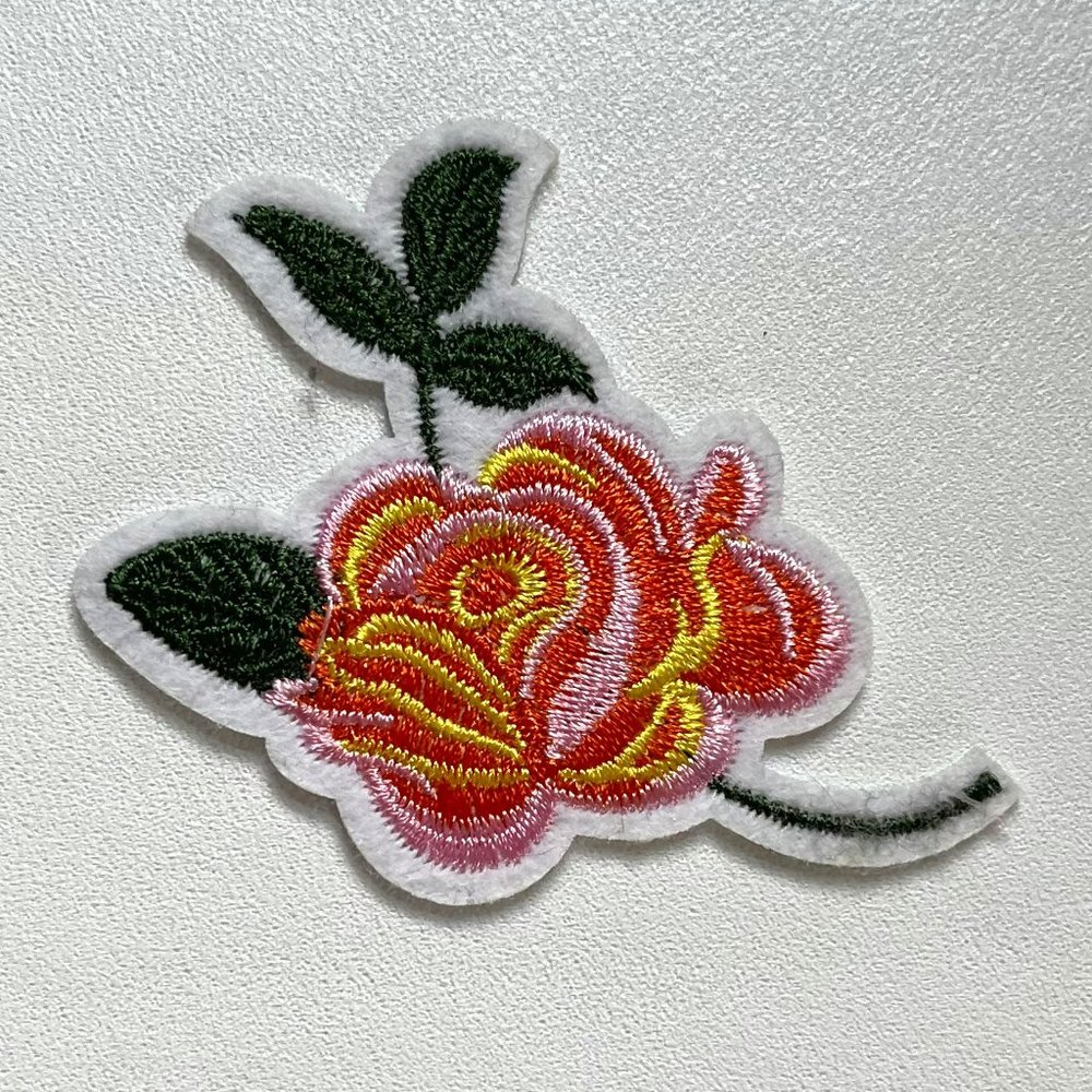 Flower patch for clothing or other fabric-like materials.